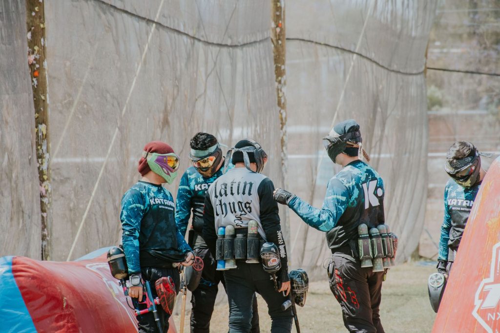 Équipe de joueurs de paintball qui prépare sa stratégie pendant une partie